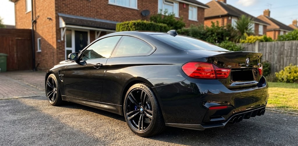 Aaron K's BMW M4 with refurbished gloss black alloys on a Harrow driveway