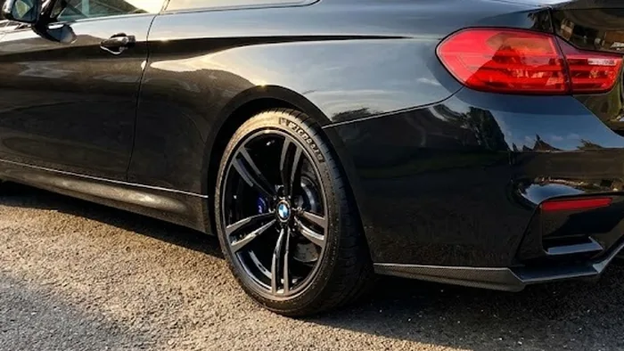 Aaron K's BMW M4 with refurbished gloss black alloys on a Harrow driveway